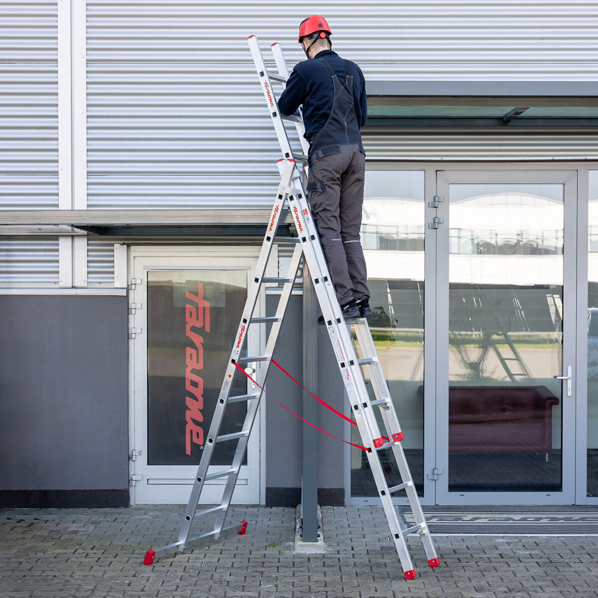 Drabina aluminiowa 3-elementowa Faraone AK ze stabilizatorem podczas pracy przy elewacji